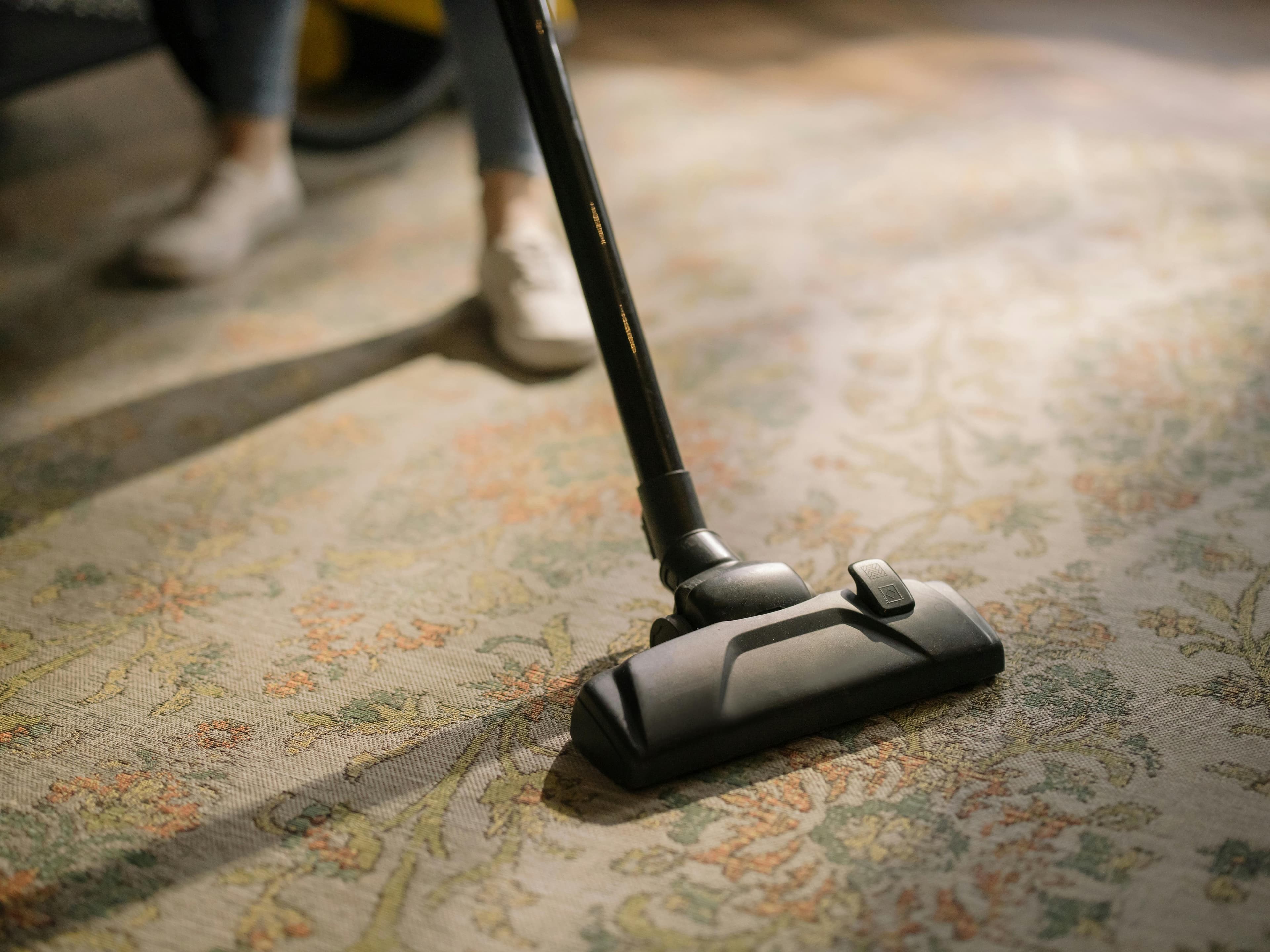 Modern black vacuum cleaner on a light floor
